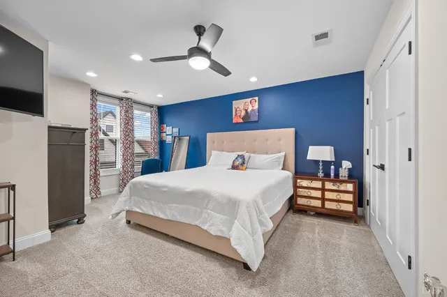 a view of a patio with chairs and a grill