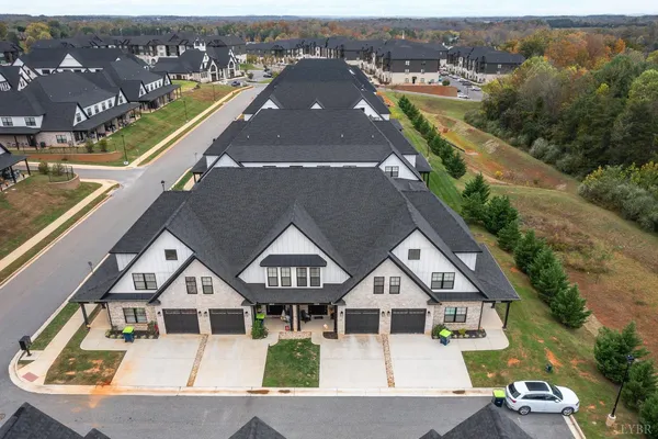 an aerial view of a house with a big yard