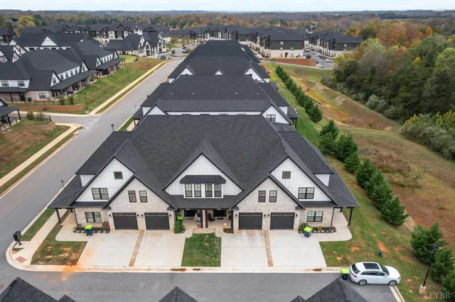 an aerial view of a house with a big yard