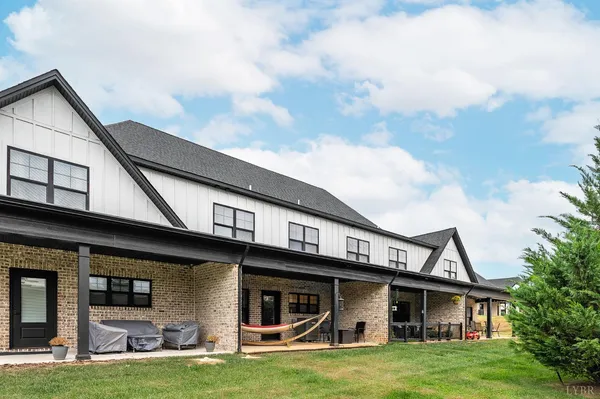 a living room with furniture wooden floor and a chandelier
