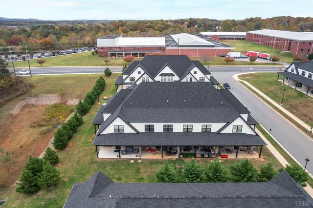 a view of a dining room with furniture and a floor to ceiling window