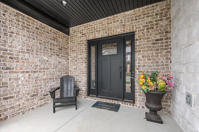a front view of a house with outdoor seating