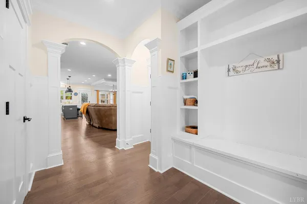 a view of a hallway with wooden floor