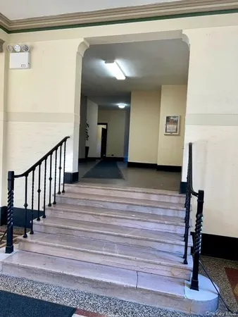 a view of a hallway with wooden floor and entryway