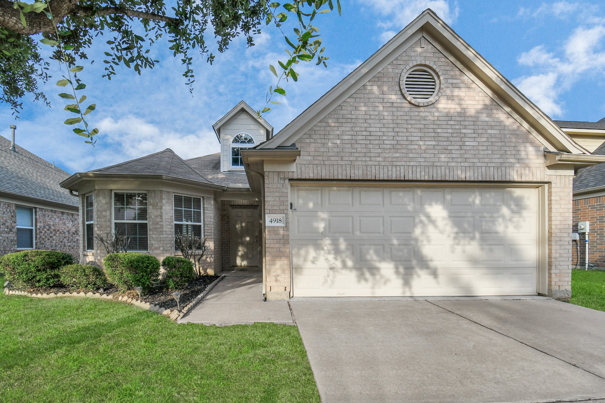 a aerial view of a house with a yard and potted plants