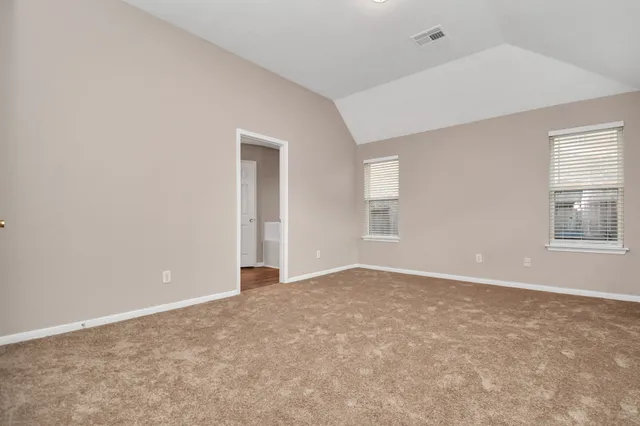 an empty room with windows and closet