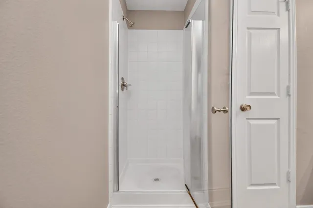 a bathroom with a glass shower door