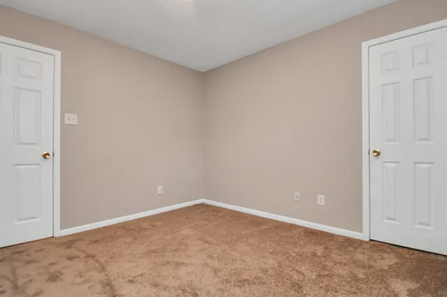 a view of a hallway with closet and front door