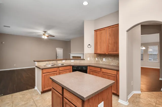 a kitchen with a stove a sink and a refrigerator