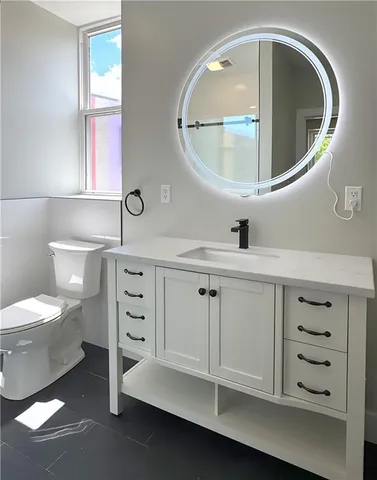 a bathroom with a sink a vanity and a mirror