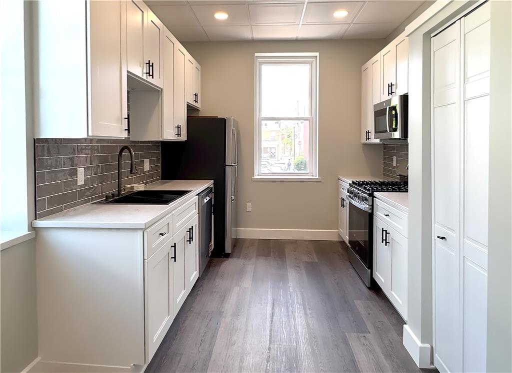 422 Walnut Street, Unit 1 Sewickley, PA 15143 - Photo 5 of 13 a kitchen with stainless steel appliances granite countertop a stove a sink and a refrigerator