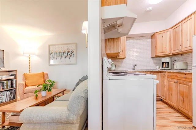 a living room with stainless steel appliances kitchen island granite countertop furniture and a kitchen view