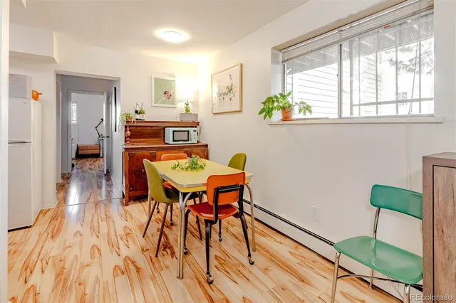 a dining room with furniture and wooden floor