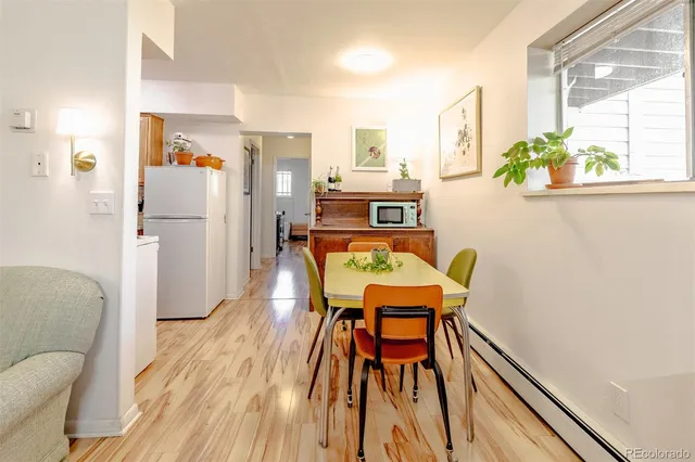 a dining room with furniture and wooden floor