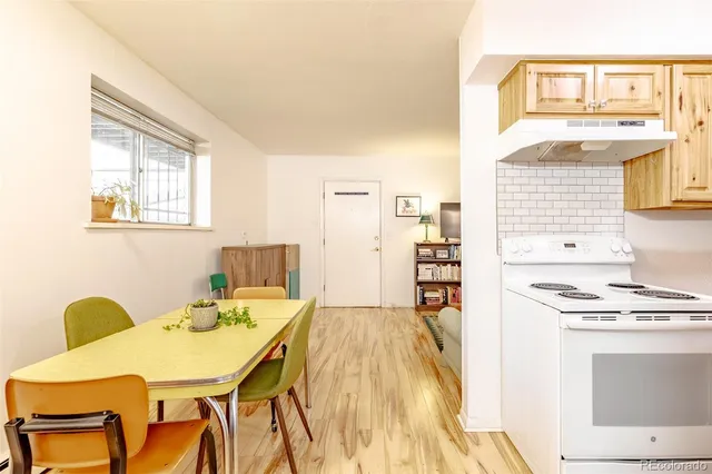 a view of a kitchen with a table and chairs