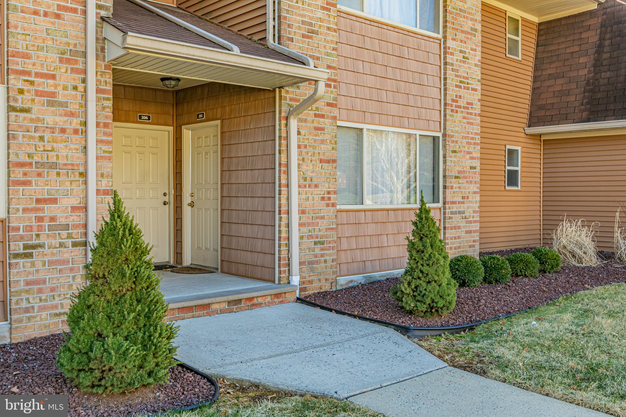 205 Mandon Court, Unit 1 Princeton, NJ 08540 - Photo 1 of 11 a front view of a house with a garden