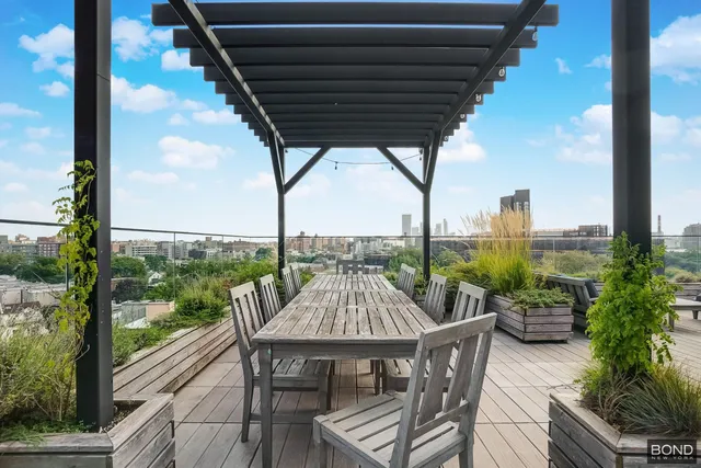 a view of a patio with a table chairs and a potted plant