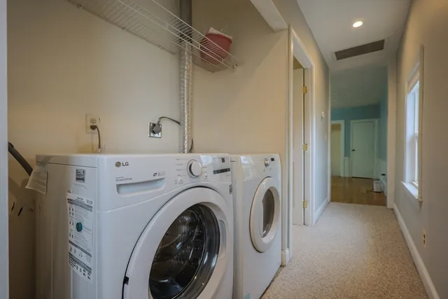 a view of a hallway with washer and dryer