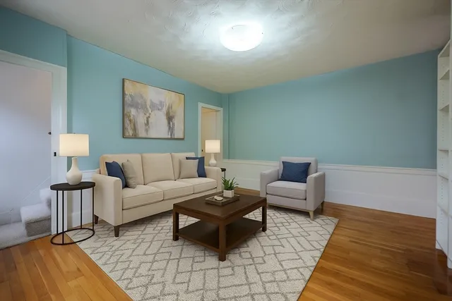 a living room with furniture and a wooden floor