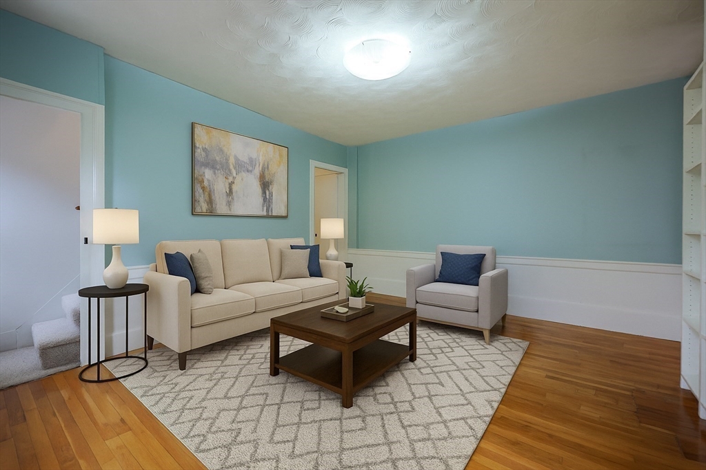 18 Beacon Place, Unit 18 Melrose, MA 02176 - Photo 17 of 28 a living room with furniture and a wooden floor
