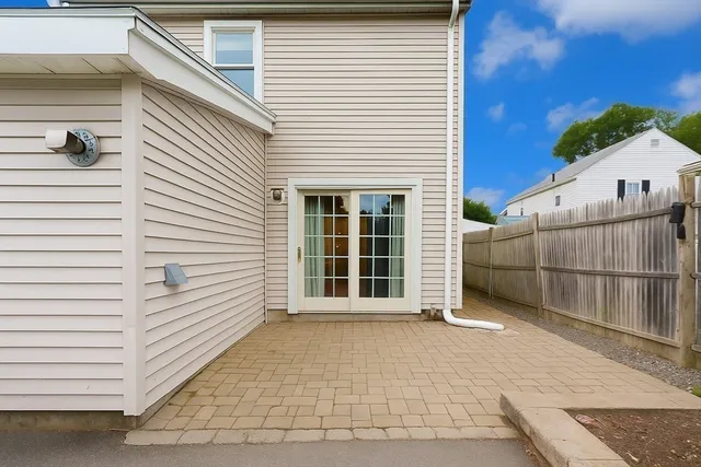 a view of a house with a wooden fence