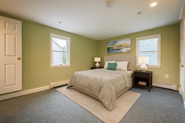 a bedroom with a bed lamps and window