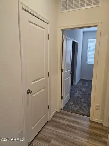 a view of hallway with wooden floor