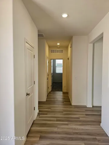 a view of a hallway with wooden floor