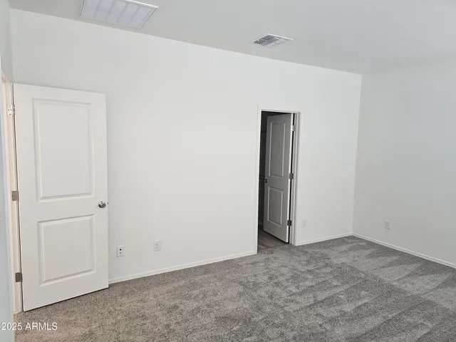 an empty room with closet area