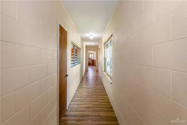 a view of a hallway with wooden floor