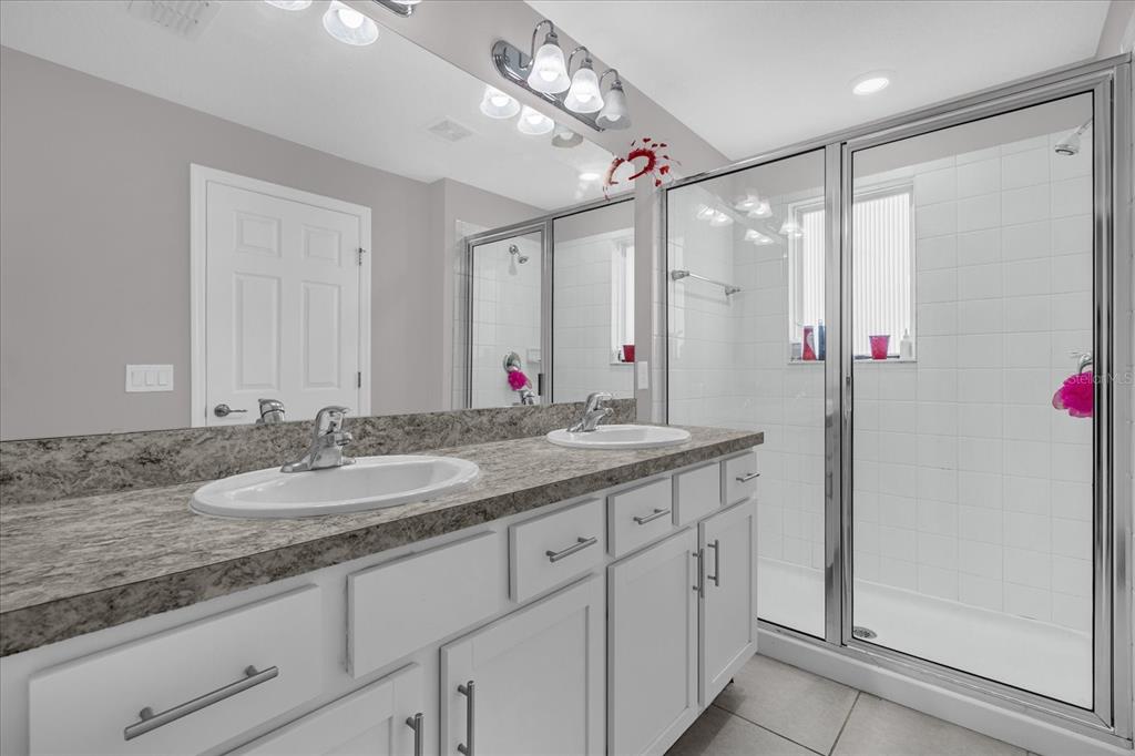 3470 Beau Road Kissimmee, FL 34746 - Photo 19 of 40 a bathroom with a granite countertop sink and a mirror