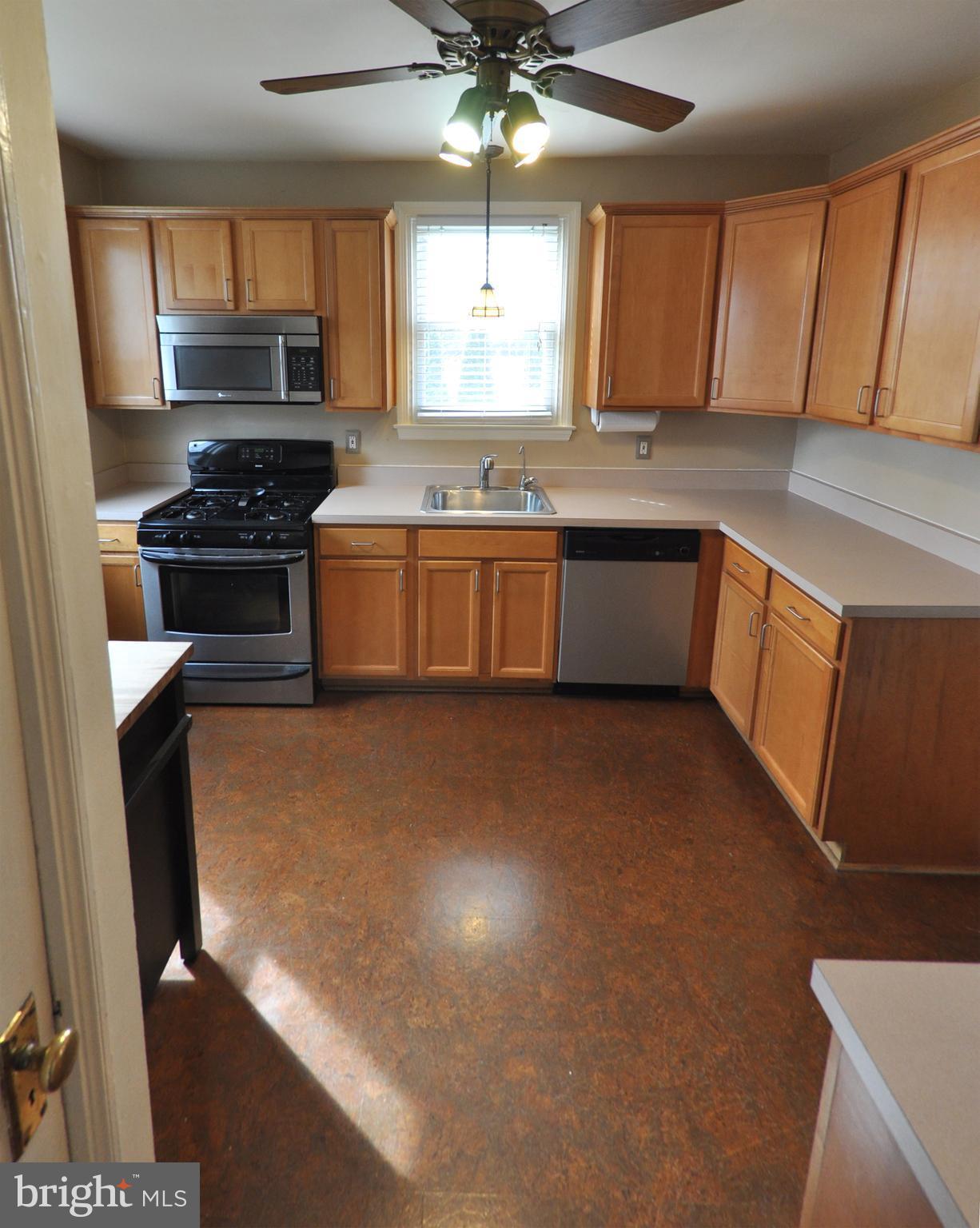308 Kingston Road Baltimore, MD 21229 - Photo 11 of 30 a kitchen with stainless steel appliances a stove a sink and a microwave