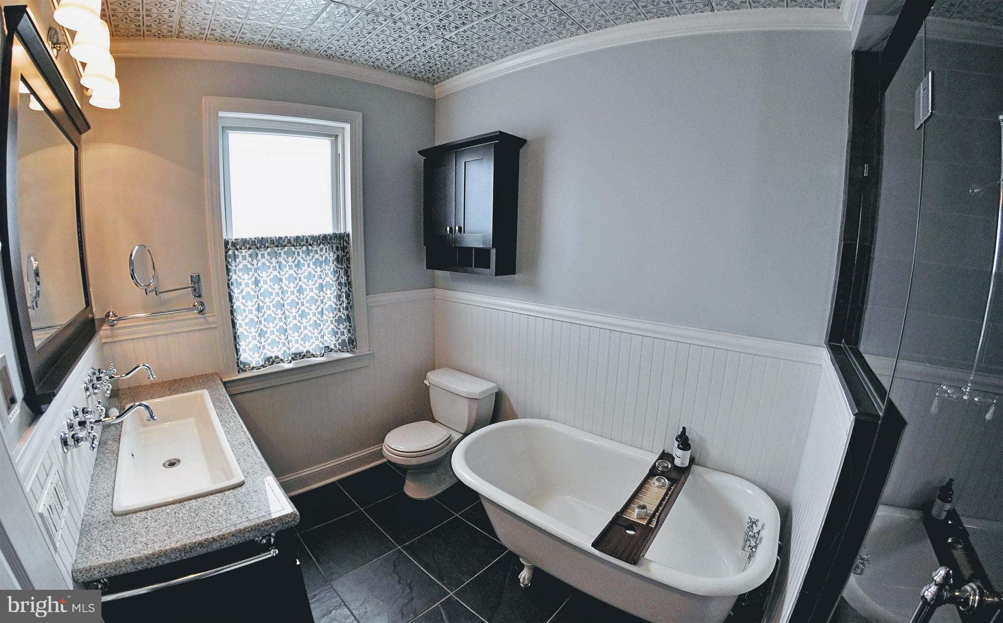 308 Kingston Road Baltimore, MD 21229 - Photo 13 of 30 a bathroom with a sink mirror bathtub and toilet