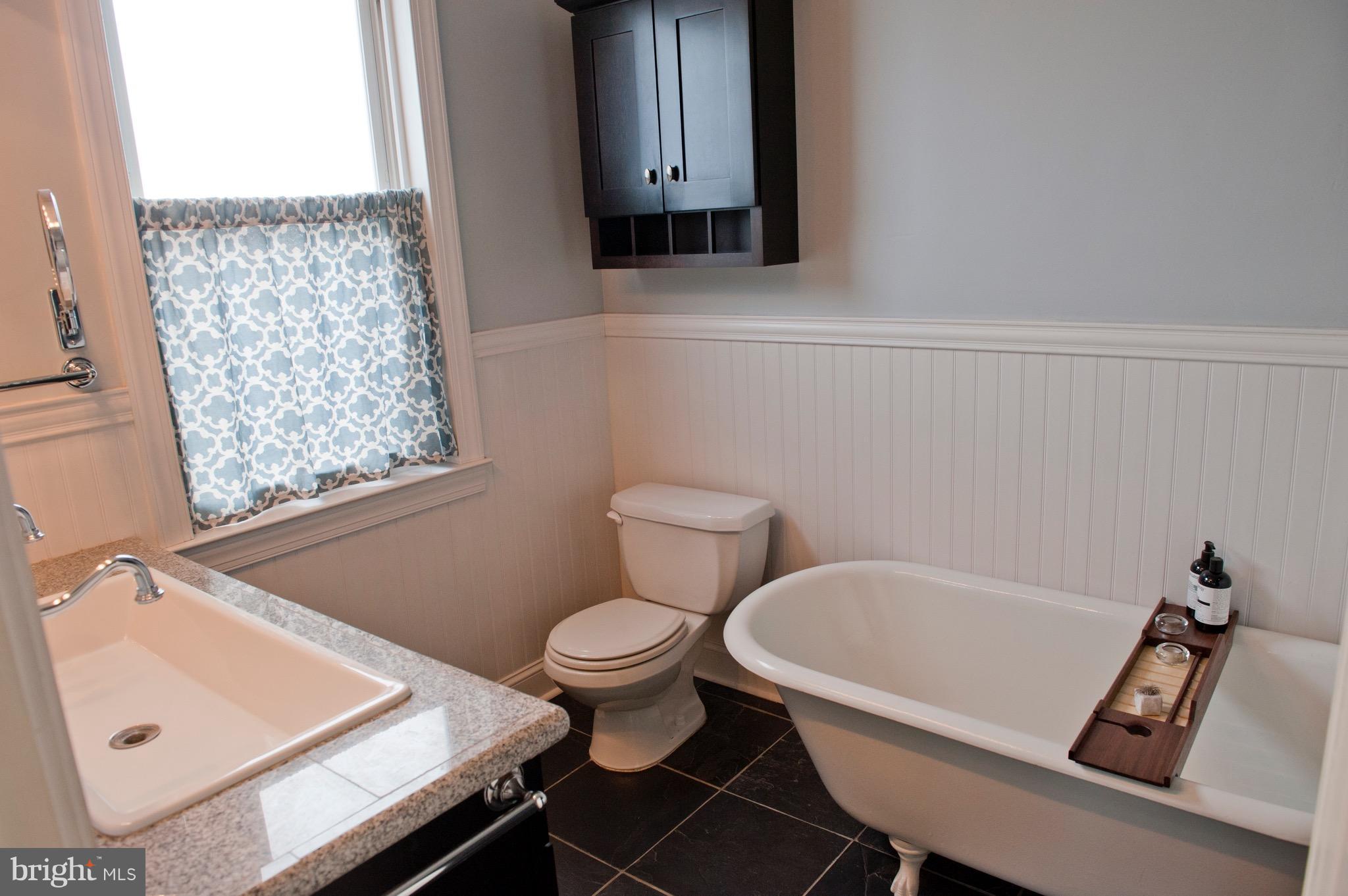 308 Kingston Road Baltimore, MD 21229 - Photo 15 of 30 a bathroom with a sink toilet and mirror