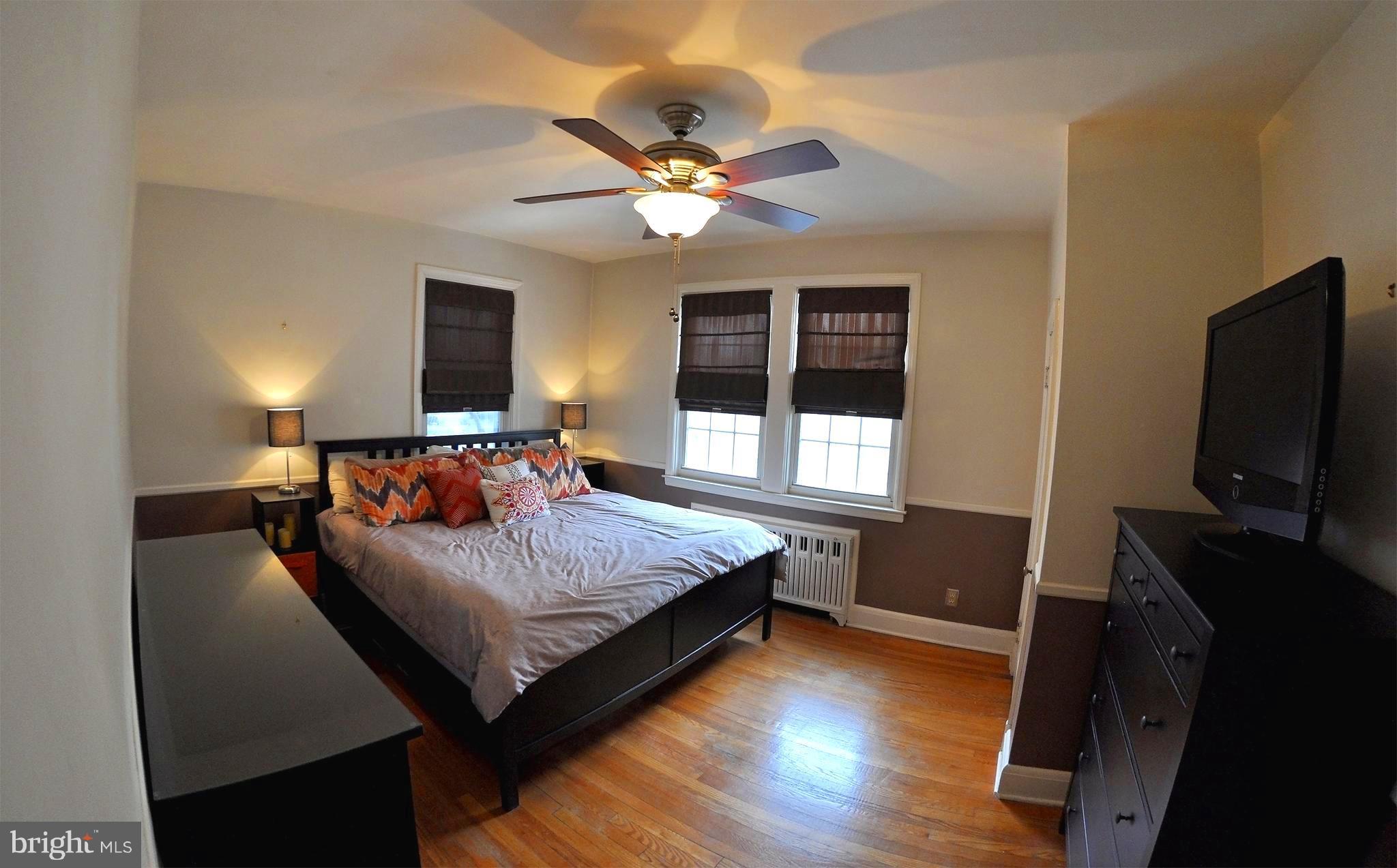 308 Kingston Road Baltimore, MD 21229 - Photo 16 of 30 a bedroom with a bed and a flat screen tv