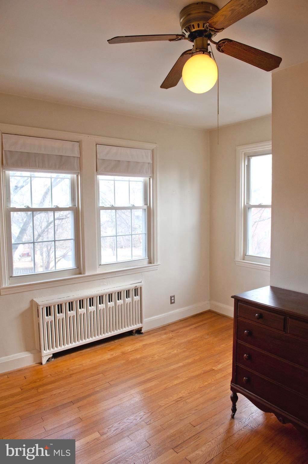 308 Kingston Road Baltimore, MD 21229 - Photo 21 of 30 a view of an empty room with a window and wooden floor
