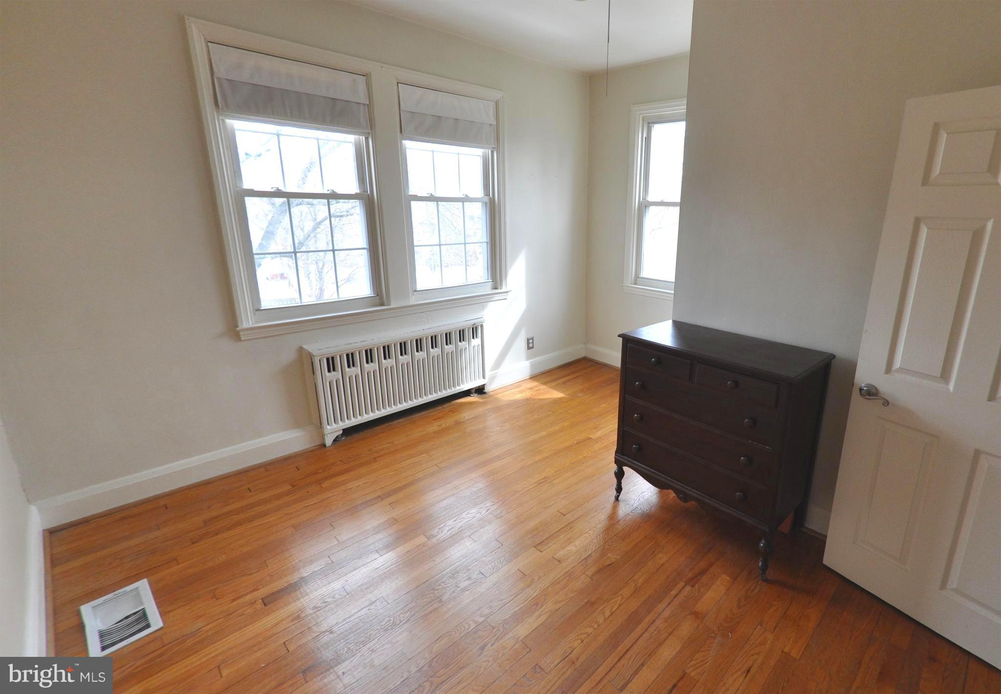 308 Kingston Road Baltimore, MD 21229 - Photo 22 of 30 an empty room with wooden floor and windows