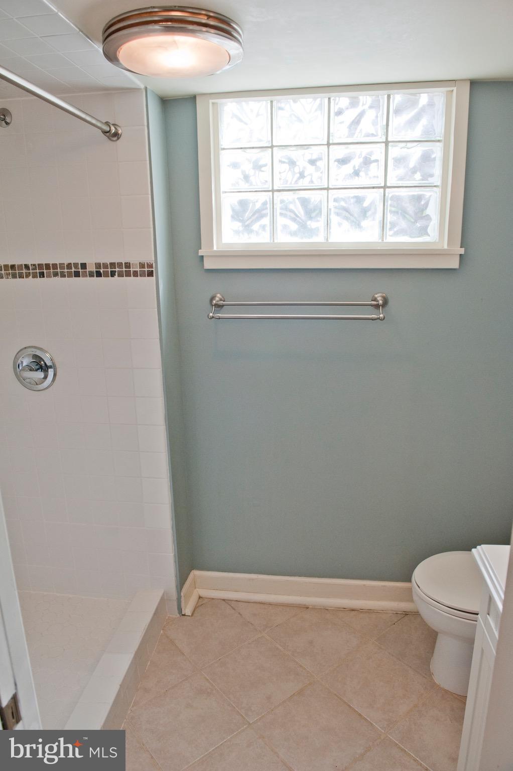 308 Kingston Road Baltimore, MD 21229 - Photo 25 of 30 a bathroom with a toilet and a window
