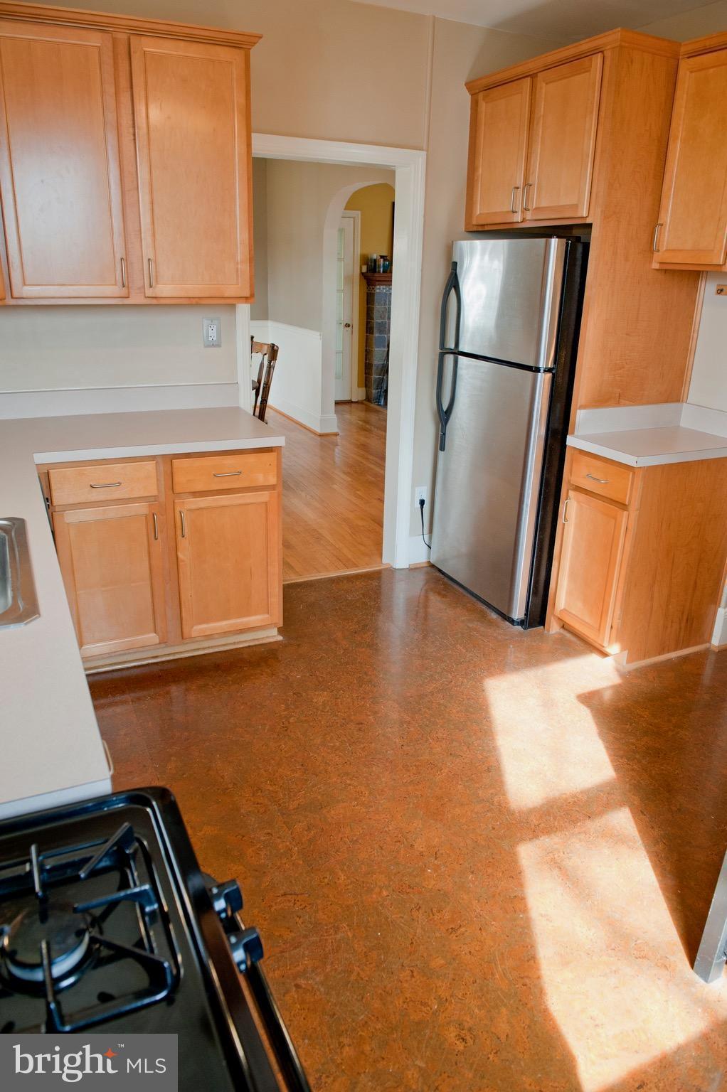 308 Kingston Road Baltimore, MD 21229 - Photo 10 of 30 a kitchen with a refrigerator and a stove top oven
