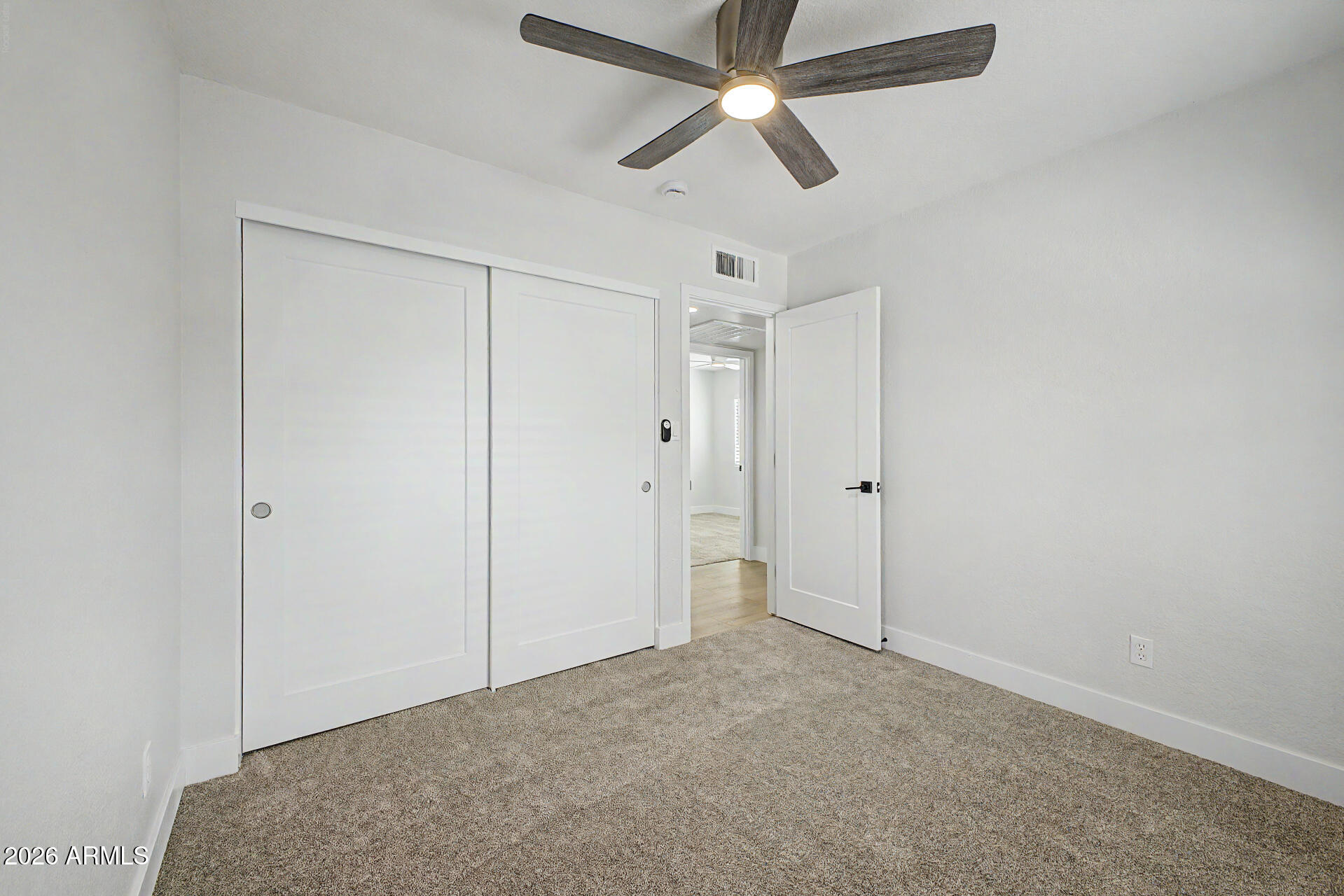 1009 West Pampa Avenue Mesa, AZ 85210 - Photo 24 of 31 an empty room with closet and a chandelier fan