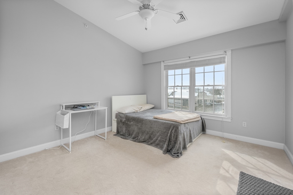 68 Center Street, Unit 13 Barnstable, MA 02601 - Photo 16 of 29 a spacious bedroom with a bed and a window