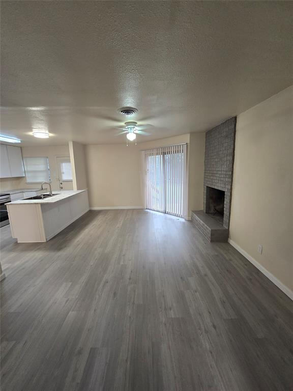 5616 Grassy Ridge Trail Dallas, TX 75241 - Photo 2 of 11 a view of a room with wooden floor and a kitchen
