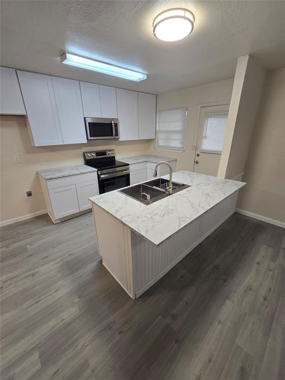 5616 Grassy Ridge Trail Dallas, TX 75241 - Photo 3 of 11 a kitchen with granite countertop a stove a sink and a microwave
