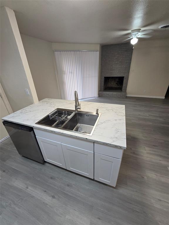 5616 Grassy Ridge Trail Dallas, TX 75241 - Photo 6 of 11 a kitchen with a sink and a fireplace
