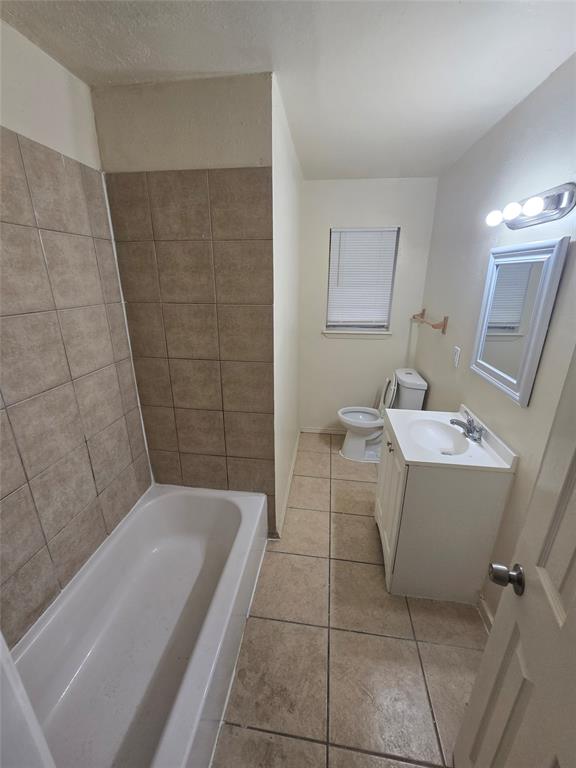 5616 Grassy Ridge Trail Dallas, TX 75241 - Photo 8 of 11 a bathroom with a sink a toilet and shower