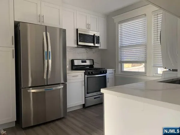 a kitchen with a refrigerator sink and microwave