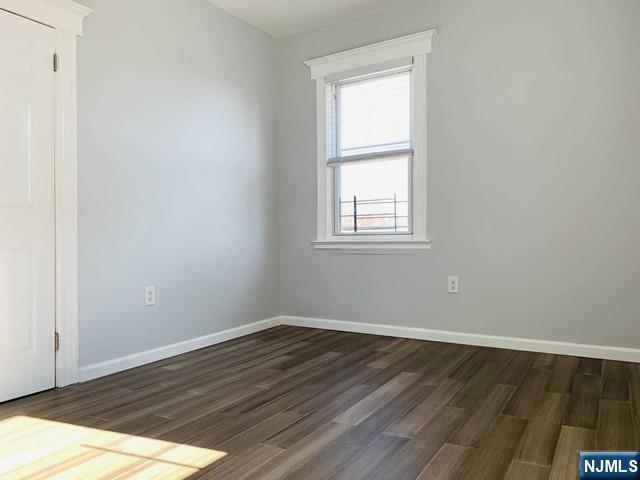 487 Summit Avenue, Unit 2 Fort Lee, NJ 07024 - Photo 11 of 17 an empty room with wooden floor and windows