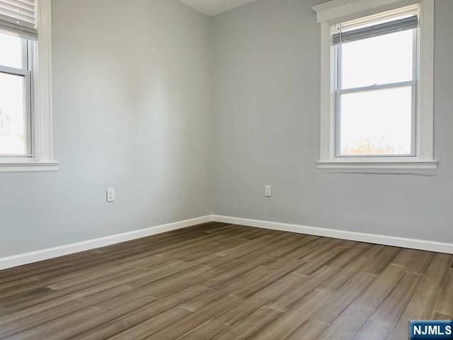 487 Summit Avenue, Unit 2 Fort Lee, NJ 07024 - Photo 15 of 17 an empty room with wooden floor and windows