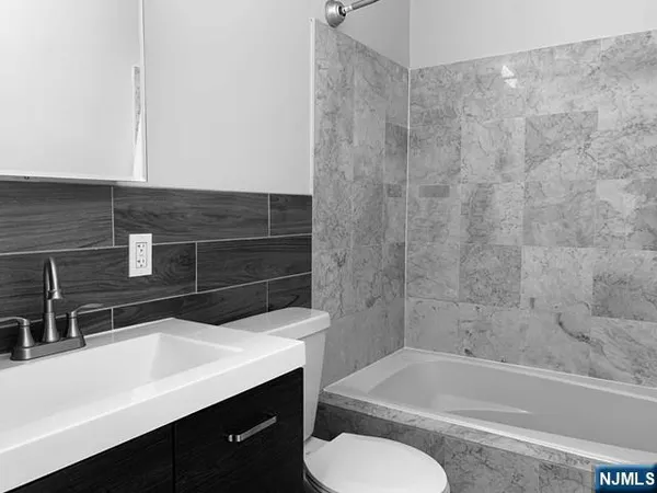 a bathroom with a sink a toilet and bathtub