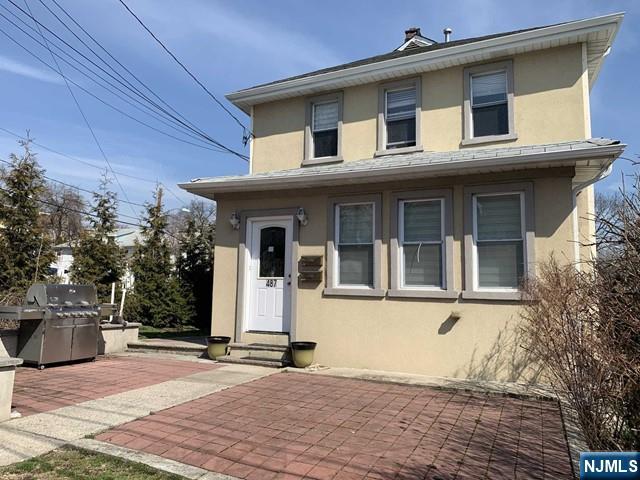 487 Summit Avenue, Unit 2 Fort Lee, NJ 07024 - Photo 2 of 17 a front view of a house with a yard